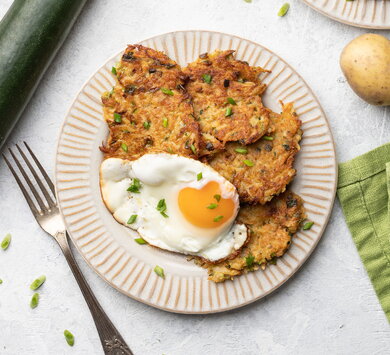 Potato and courgette pancakes served with a fried egg